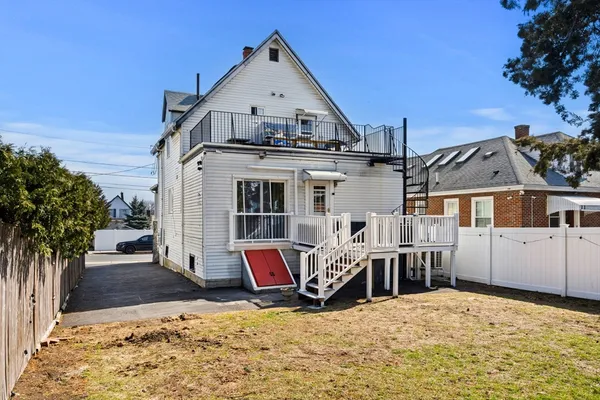a view of a house with wooden fence