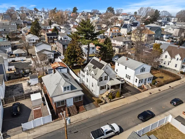 an aerial view of a residential houses with city view