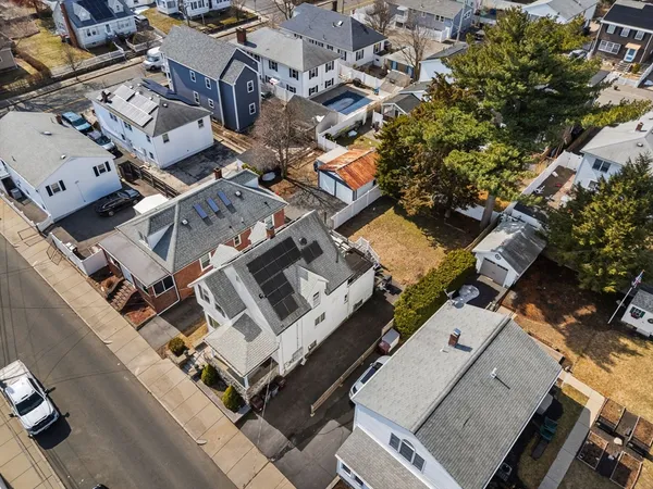 an aerial view of residential house with parking