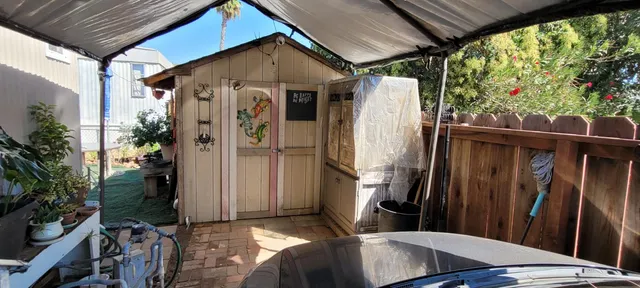 a backyard of a house with table and chairs