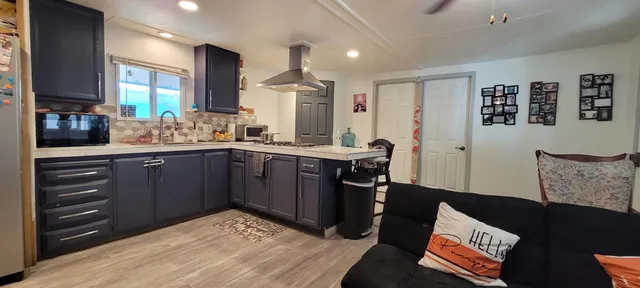 a kitchen with a sink appliances and cabinets