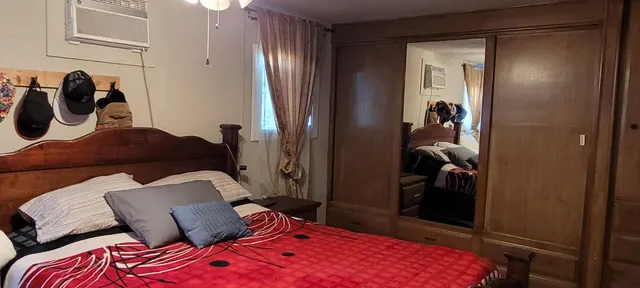 a bedroom with a bed and a mirror