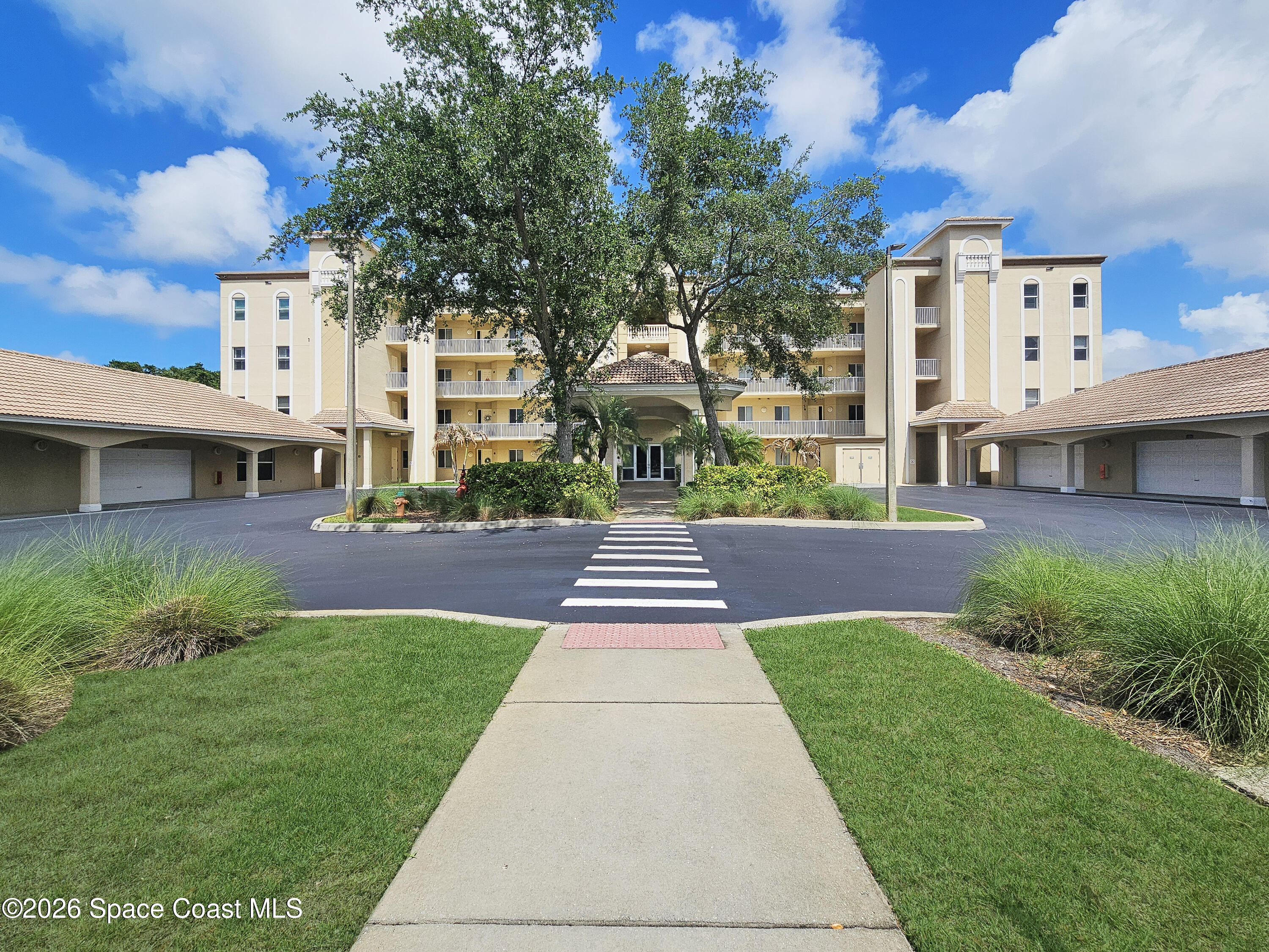 6005 Highway 1, Unit 101 Rockledge, FL 32955 - Photo 2 of 57 a front view of a building with a garden and plants
