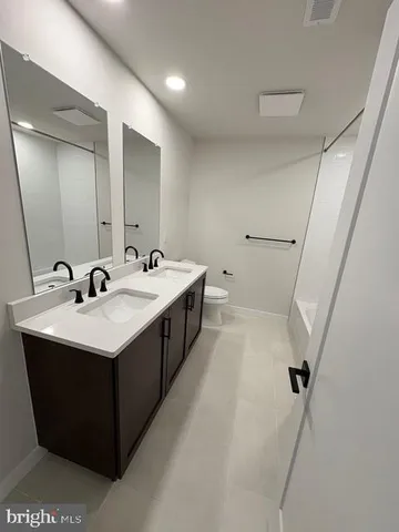 a bathroom with a sink a mirror and a toilet