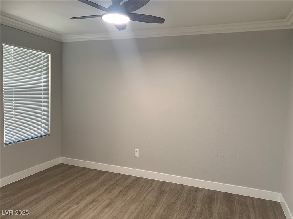 8101 West Flamingo Road, Unit 1102 Las Vegas, NV 89147 - Photo 21 of 54 Dining room featuring a ceiling fan, dark wood-style floors, and ornamental molding