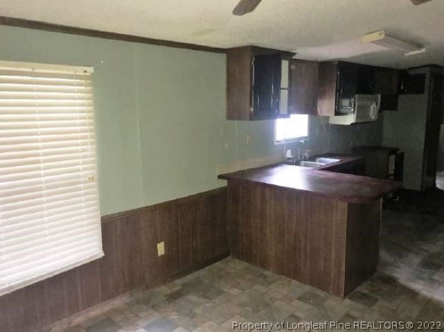 4102 Reedsford Road Clinton, NC 28328 - Photo 5 of 10 a kitchen with sink cabinets and a window