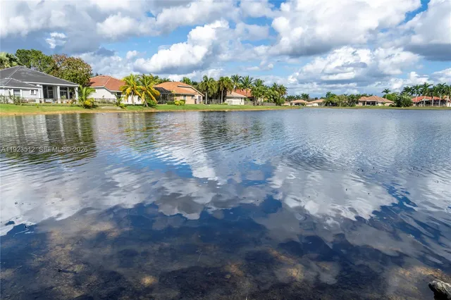 a view of a lake with houses in the back