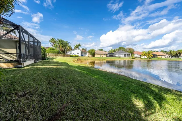 a view of a lake with houses in the back