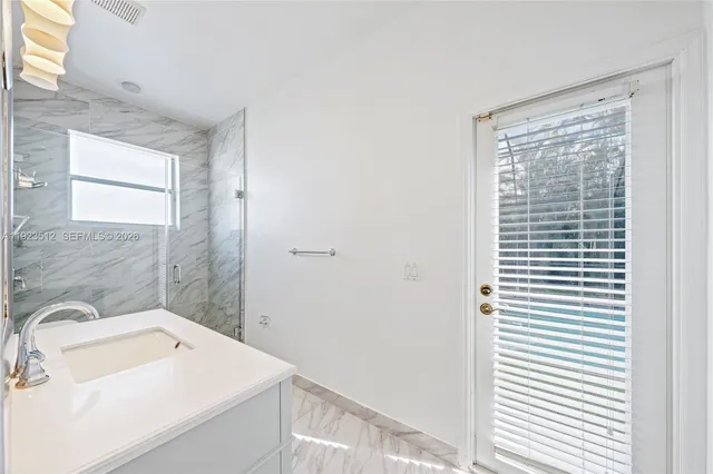 a view of a bathroom with a sink and a window