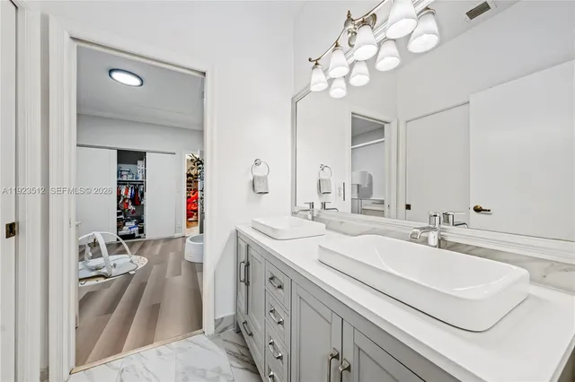 a en suite bathroom with a double vanity sink mirror and