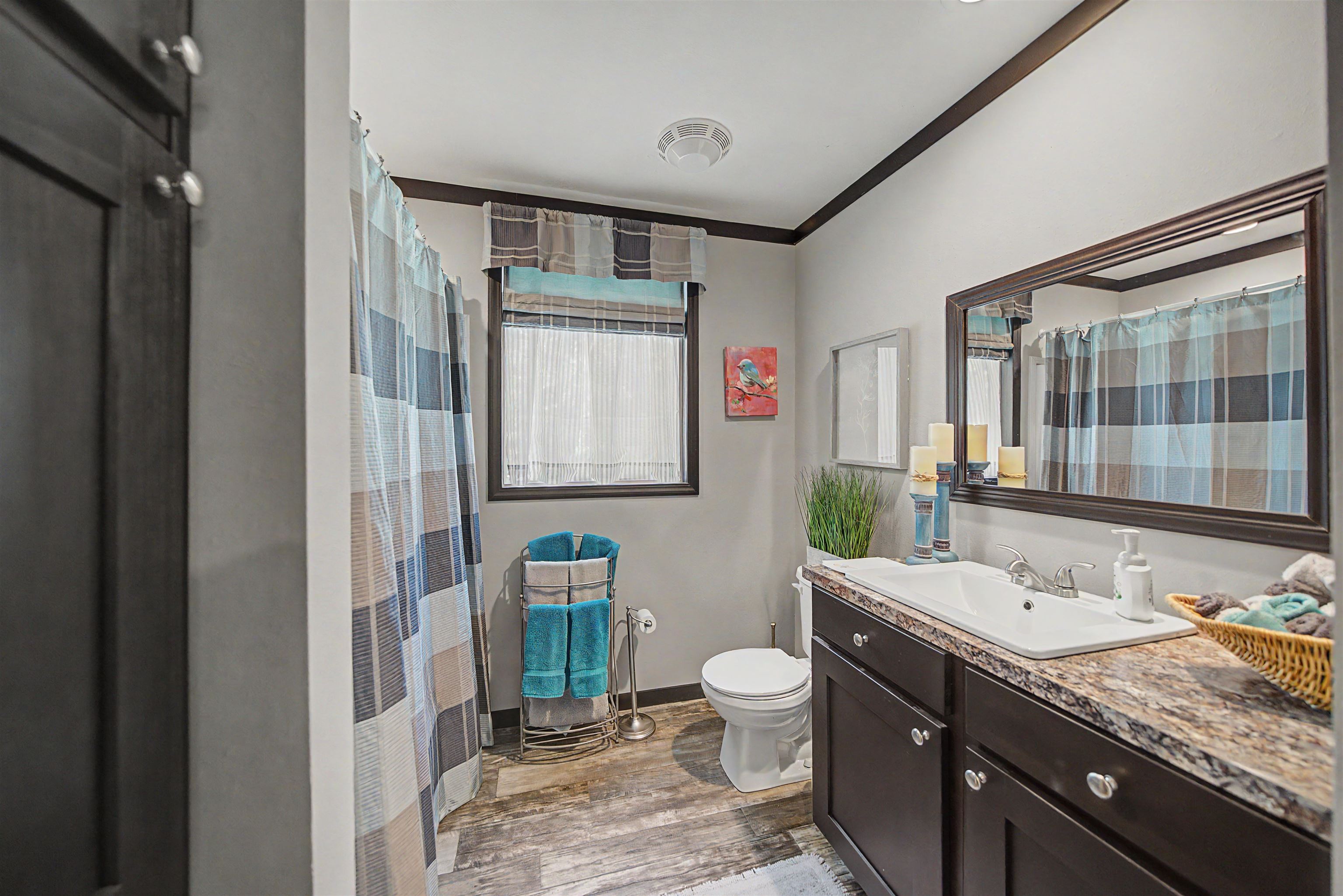 162 Matlock Road Ramer, TN 38367 - Photo 22 of 29 a bathroom with a granite countertop sink mirror vanity and toilet