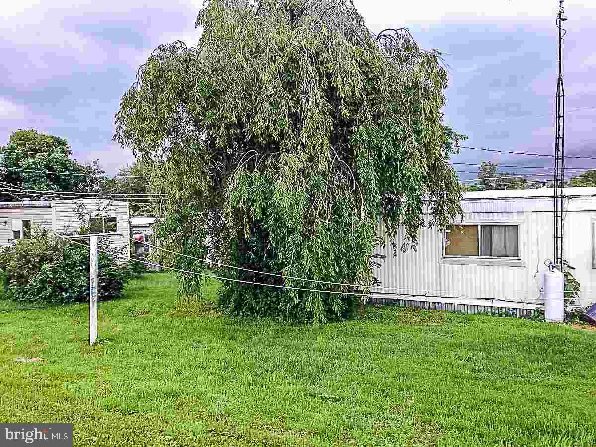 1347 Pine Grove Road Hanover, PA 17331 - Photo 3 of 18 a backyard of a house with plants and wooden fence