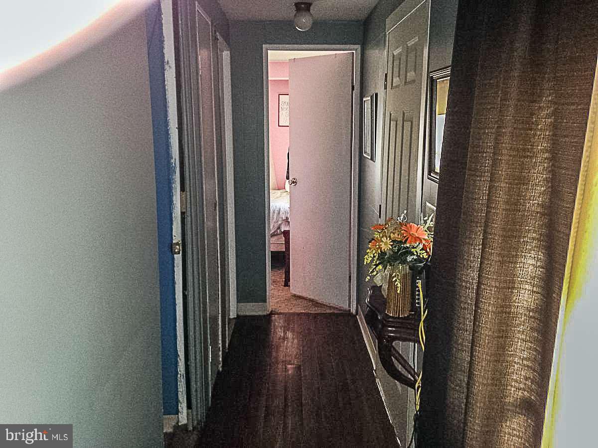 1347 Pine Grove Road Hanover, PA 17331 - Photo 9 of 18 a view of a hallway with wooden floor and stairs