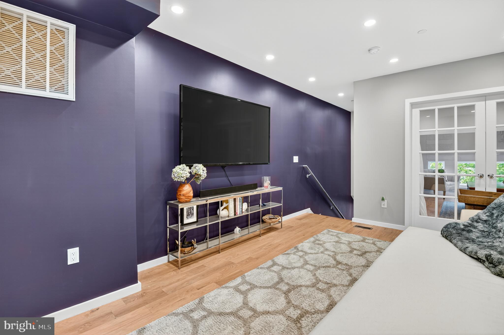 3911 Kansas Avenue Northwest, Unit 2 Washington, DC 20011 - Photo 25 of 46 a bedroom with a bed and a flat screen tv