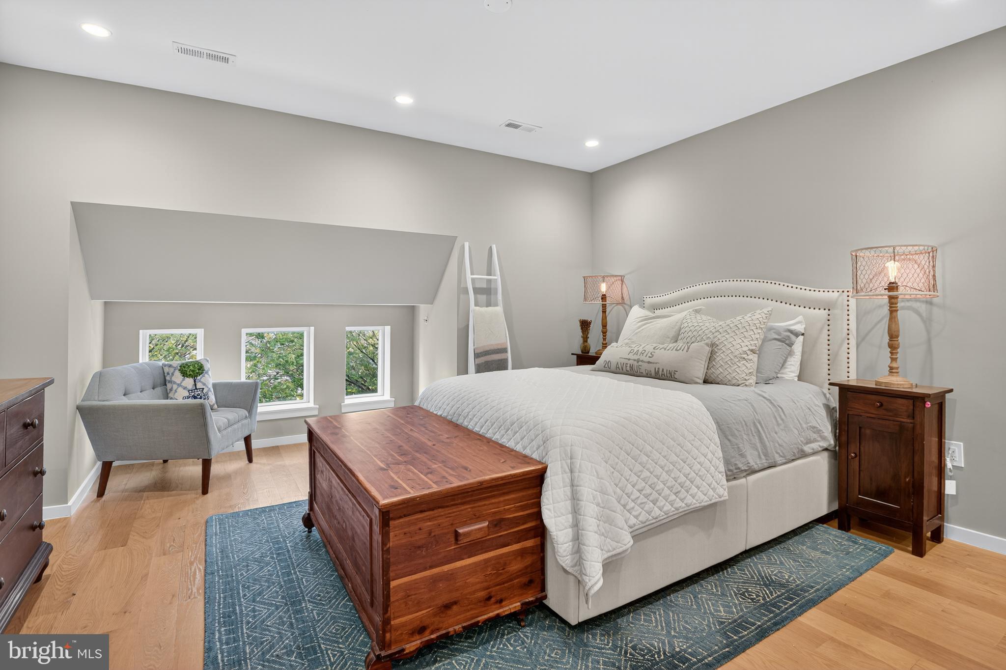 3911 Kansas Avenue Northwest, Unit 2 Washington, DC 20011 - Photo 27 of 46 a spacious bedroom with a bed and wooden floor