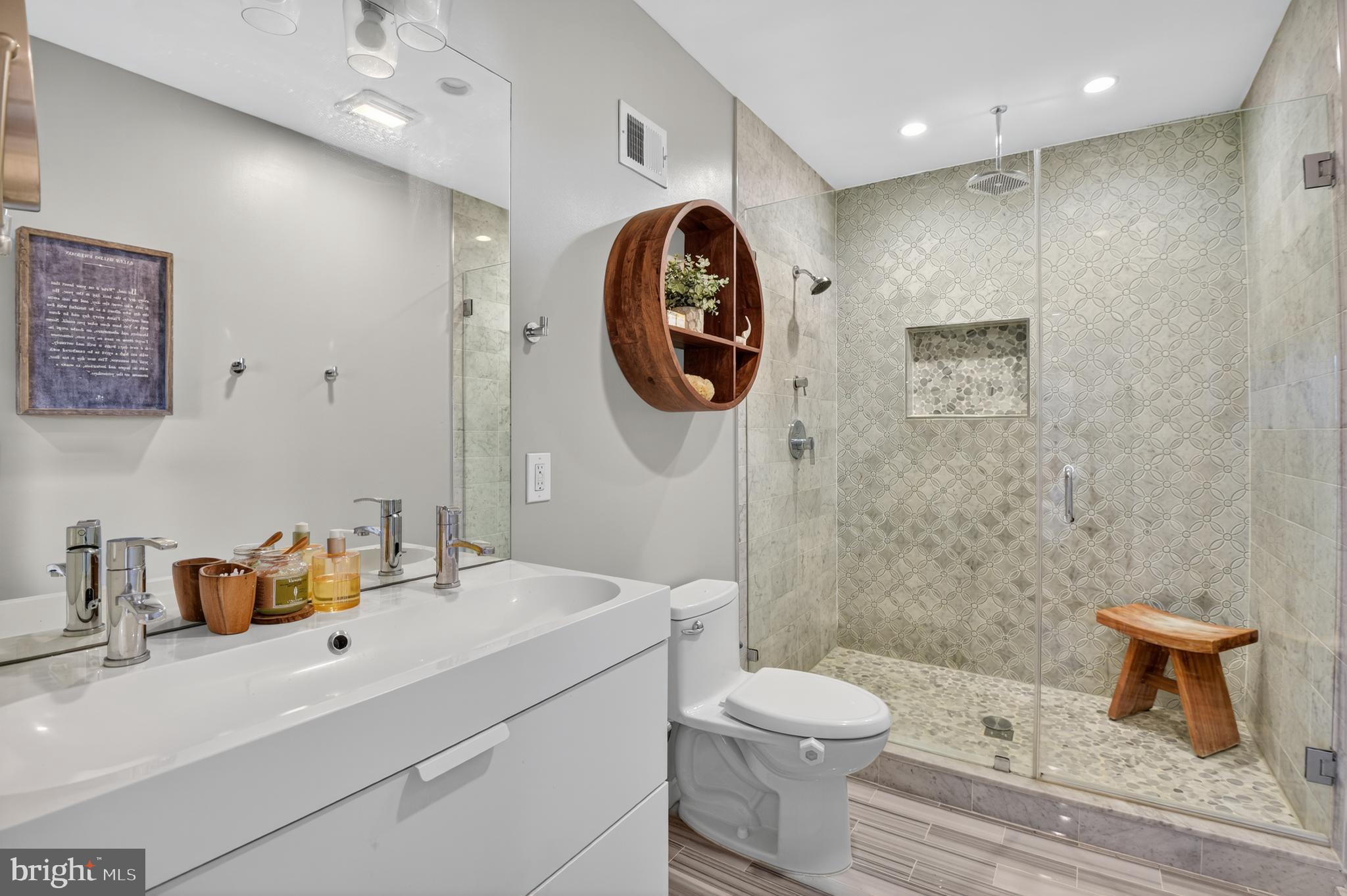 3911 Kansas Avenue Northwest, Unit 2 Washington, DC 20011 - Photo 32 of 46 a bathroom with a toilet a sink and mirror