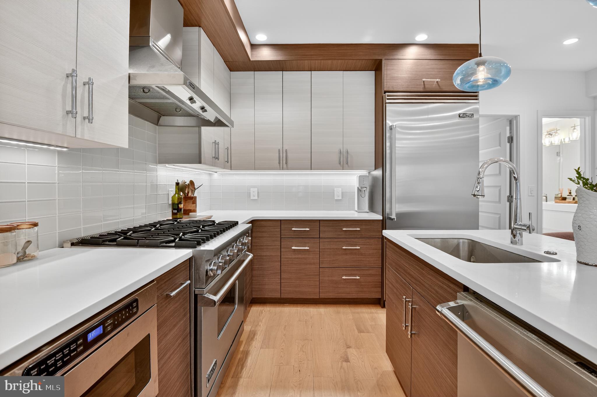 3911 Kansas Avenue Northwest, Unit 2 Washington, DC 20011 - Photo 7 of 46 a kitchen with stainless steel appliances granite countertop a sink and a stove