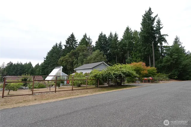 a view of street with houses and trees in the background