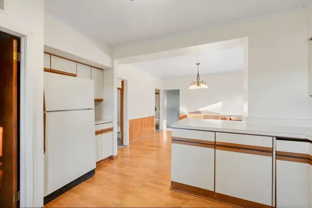 a kitchen with kitchen island a refrigerator a stove a sink and a refrigerator