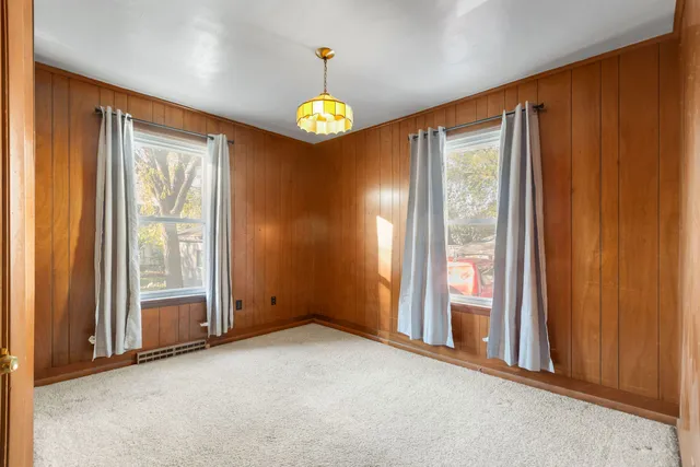 an empty room with windows and painted walls