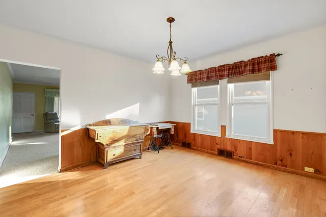 a living room with a balcony furniture and a chandelier