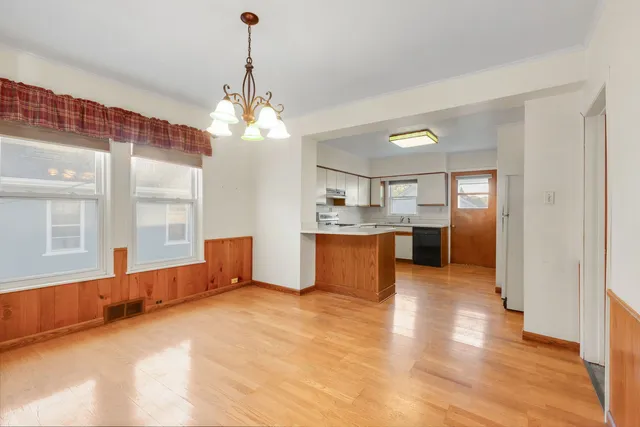 a large kitchen with a window and stainless steel appliances