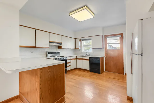 a kitchen with stainless steel appliances granite countertop a refrigerator sink and cabinets