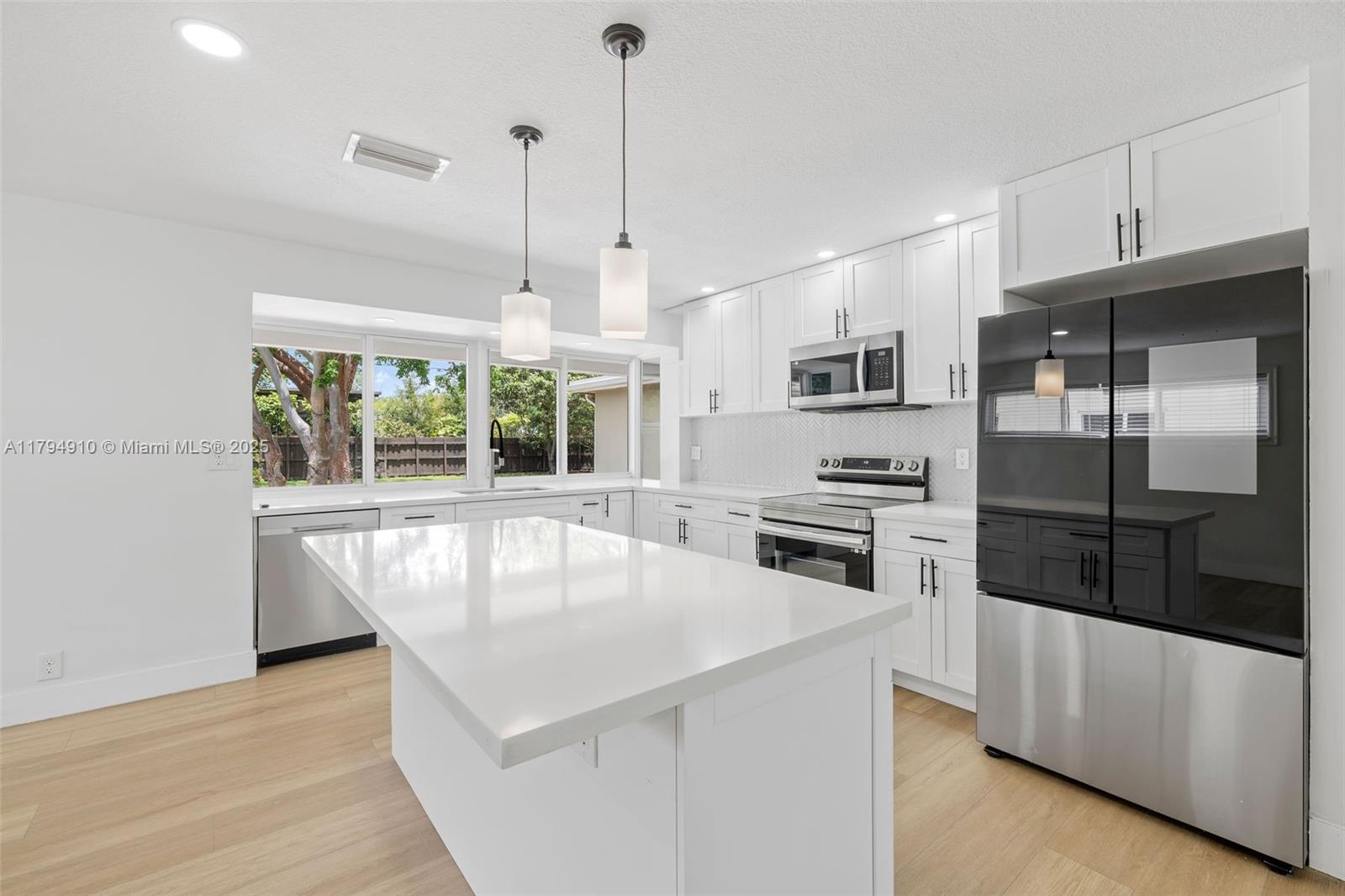 4401 Madison Street Hollywood, FL 33021 - Photo 1 of 27 a kitchen with stainless steel appliances a stove a refrigerator and a sink