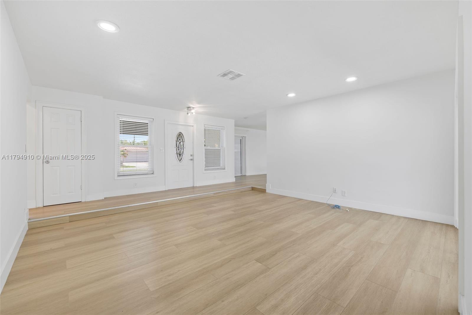 4401 Madison Street Hollywood, FL 33021 - Photo 11 of 27 an empty room with wooden floor and windows