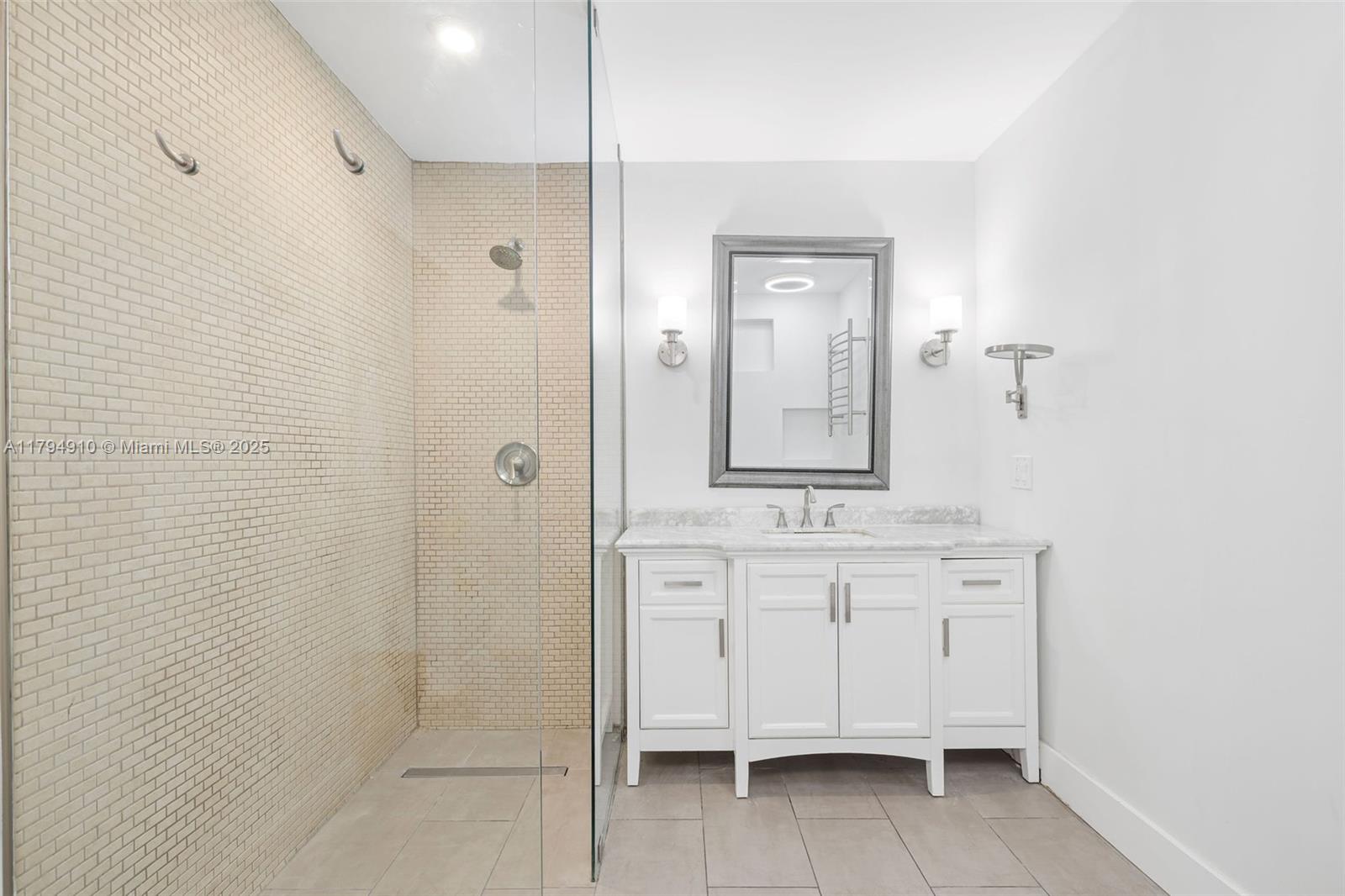 4401 Madison Street Hollywood, FL 33021 - Photo 16 of 27 a bathroom with a granite countertop sink a mirror and a shower