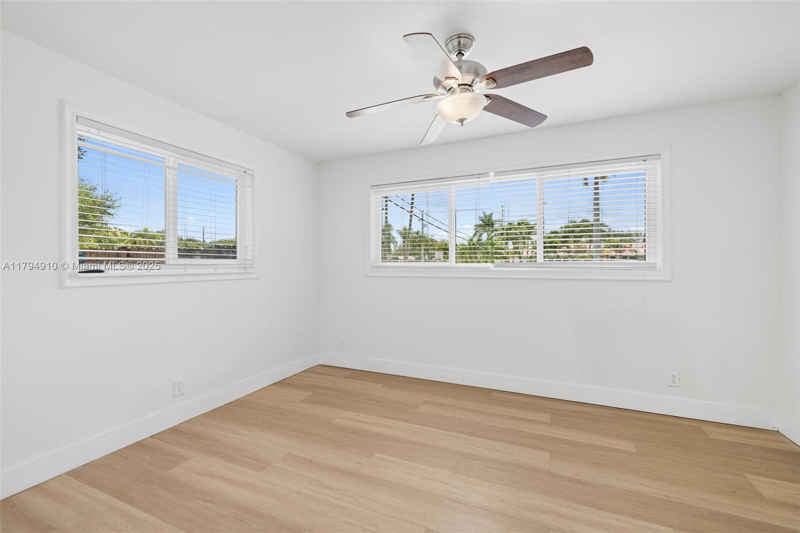 4401 Madison Street Hollywood, FL 33021 - Photo 17 of 27 a view of an empty room with wooden floor and a ceiling fan