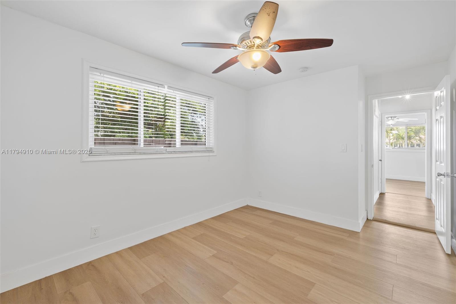 4401 Madison Street Hollywood, FL 33021 - Photo 19 of 27 an empty room with wooden floor fan and windows