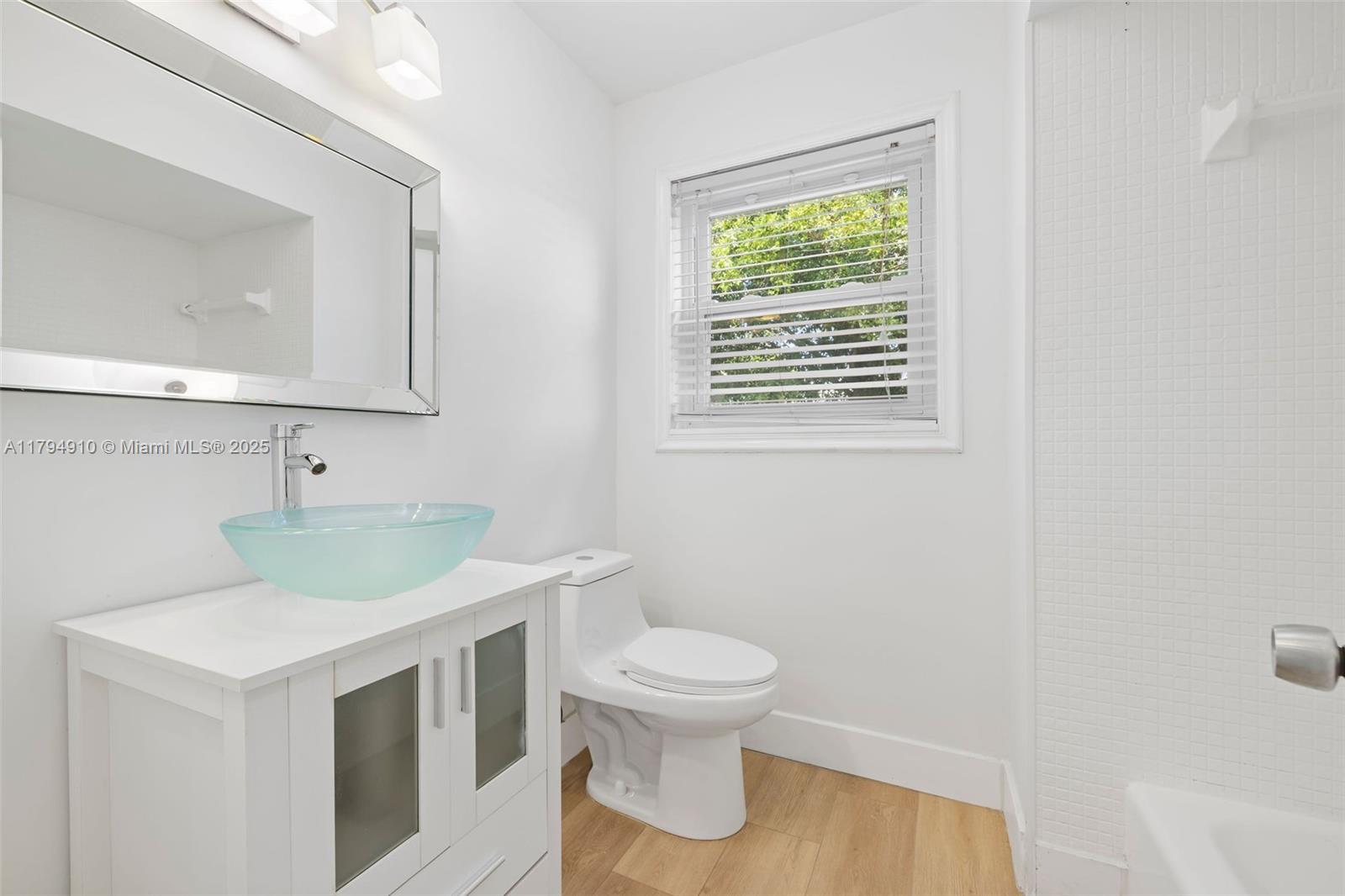 4401 Madison Street Hollywood, FL 33021 - Photo 20 of 27 a bathroom with a toilet a sink and a window