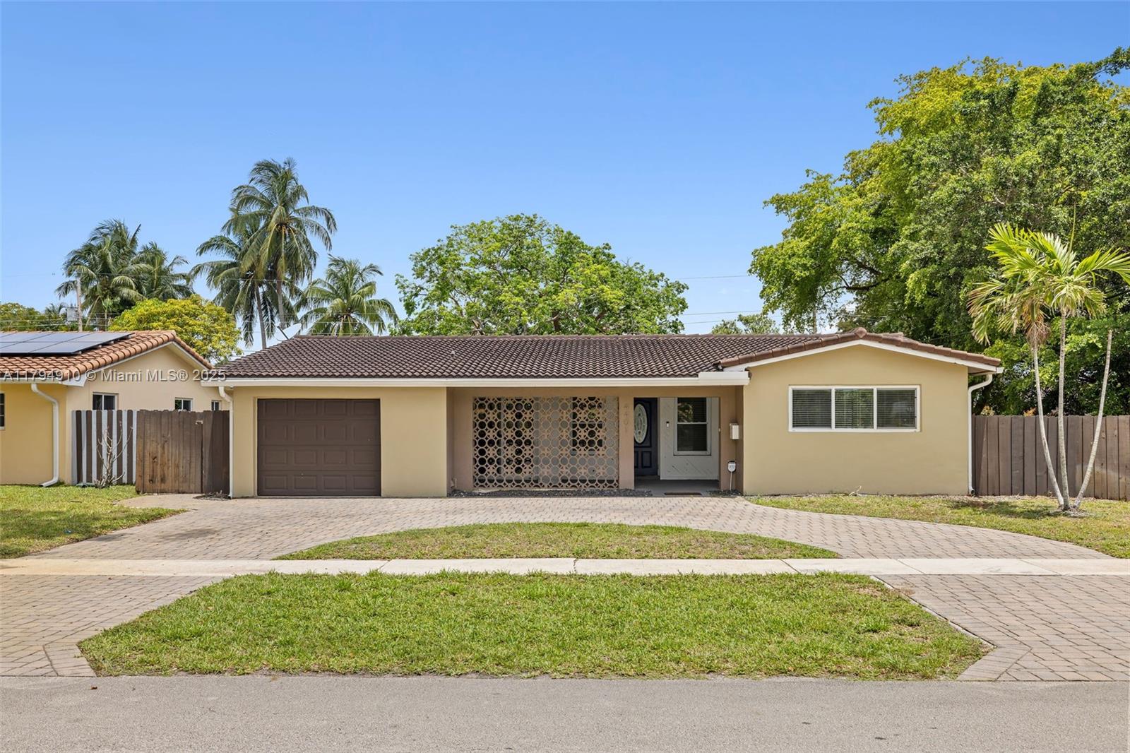 4401 Madison Street Hollywood, FL 33021 - Photo 2 of 27 a front view of a house with a garden