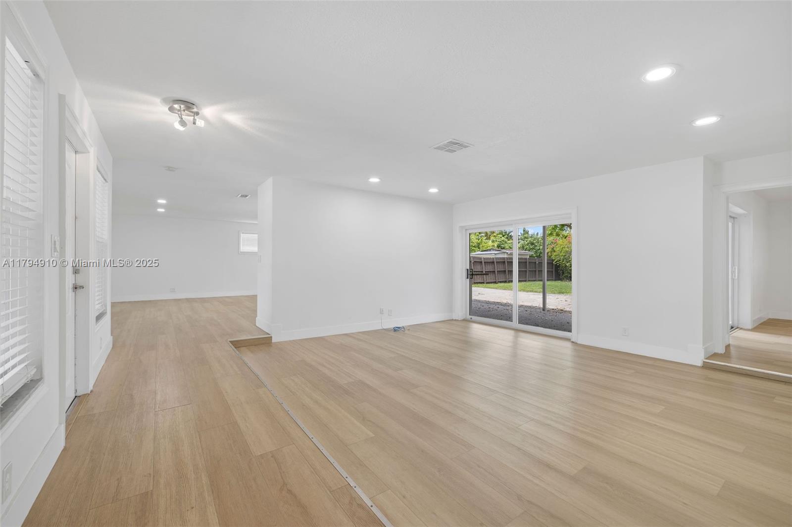 4401 Madison Street Hollywood, FL 33021 - Photo 5 of 27 wooden floor in an empty room with a window