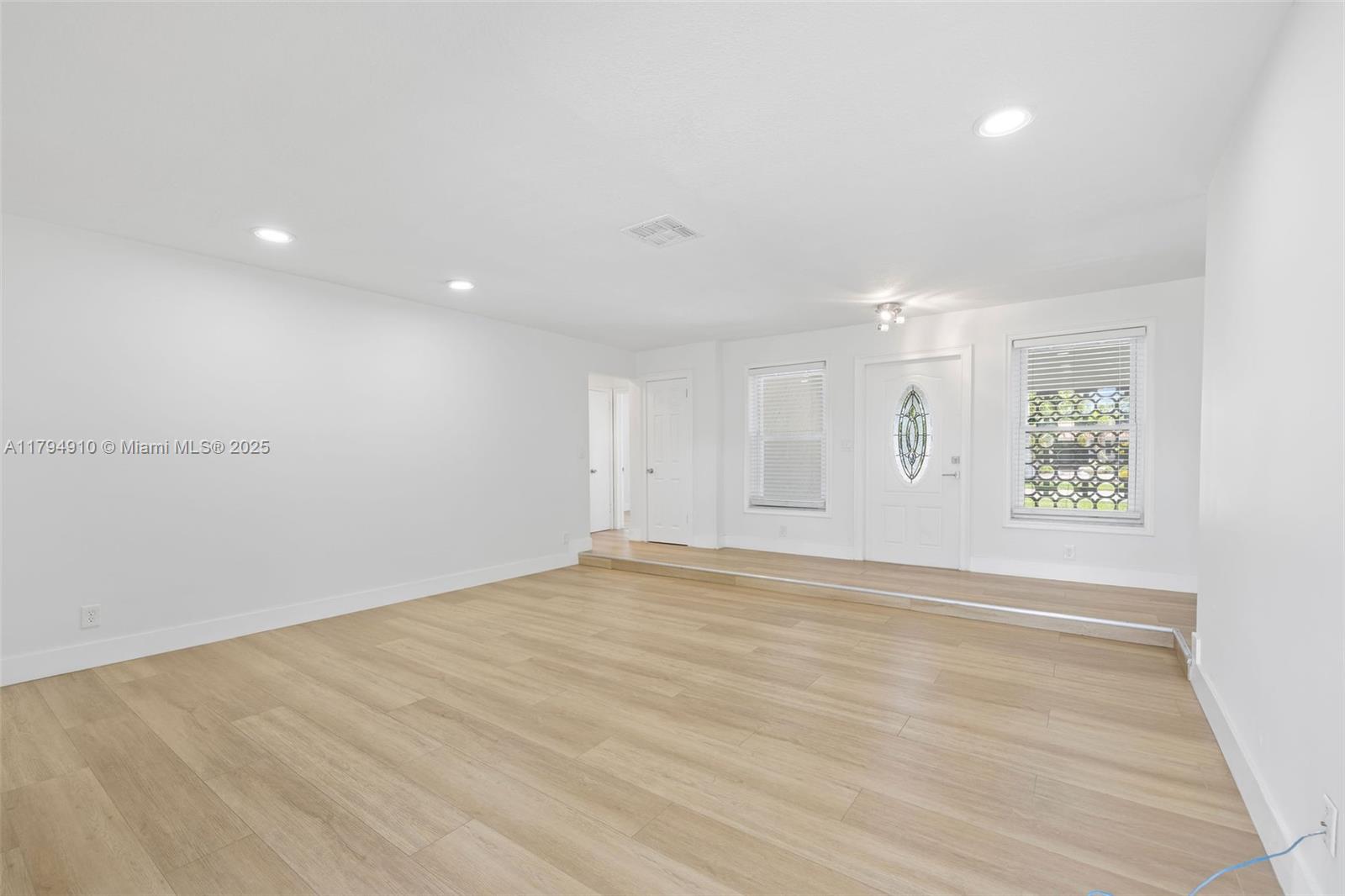 4401 Madison Street Hollywood, FL 33021 - Photo 10 of 27 a view of an empty room with wooden floor and a window