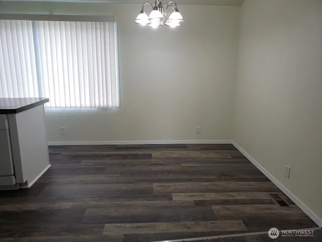 a view of wooden floor and windows in a room