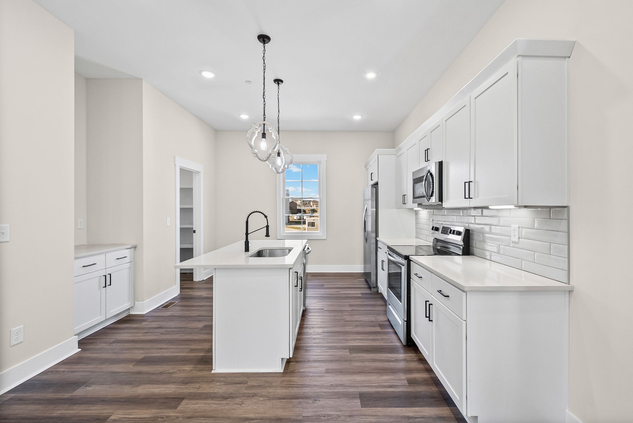 434 Centre Street Pleasant View, TN 37146 - Photo 12 of 44 a large kitchen with stainless steel appliances a large center island attached withe living room