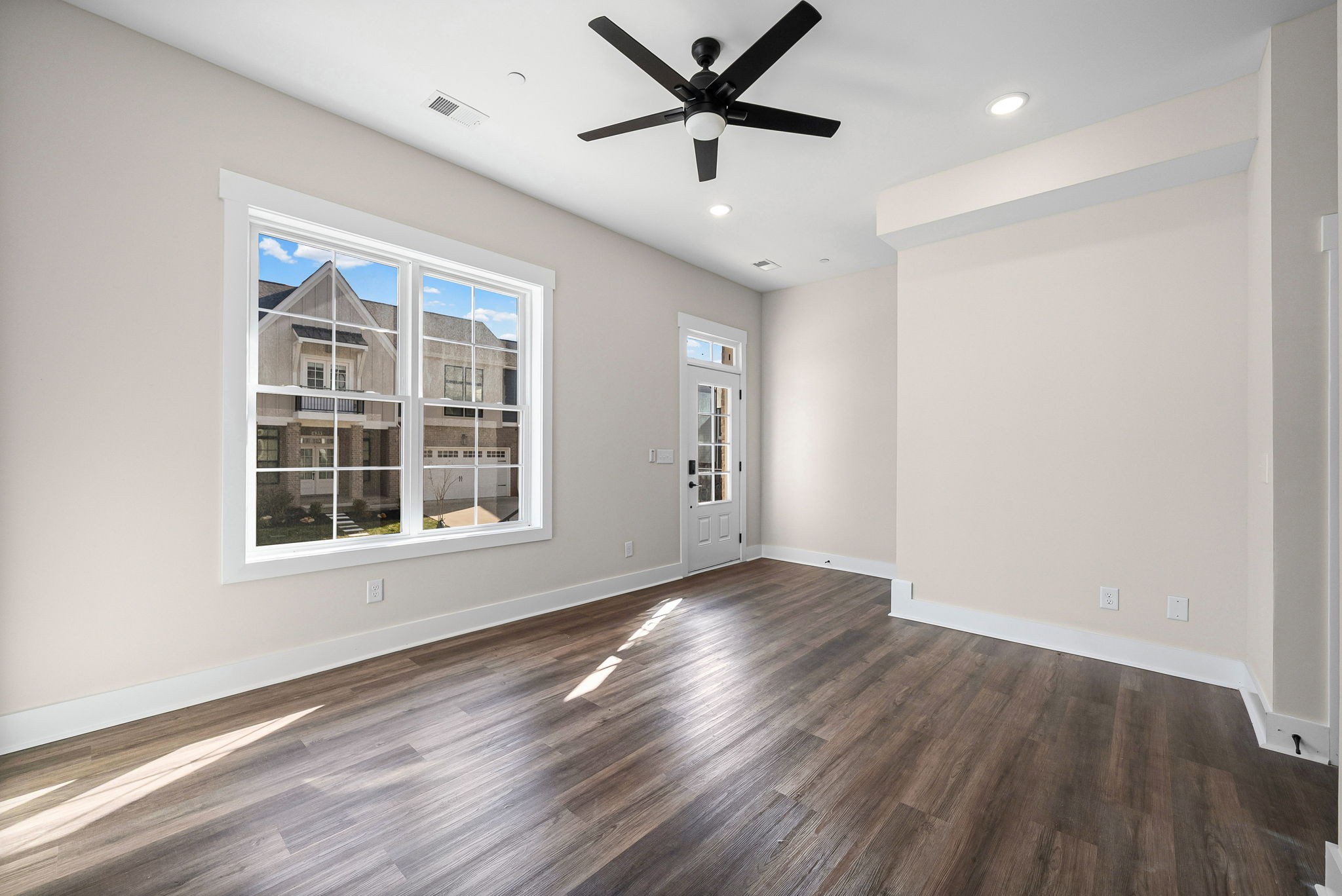 434 Centre Street Pleasant View, TN 37146 - Photo 4 of 44 an empty room with wooden floor and windows