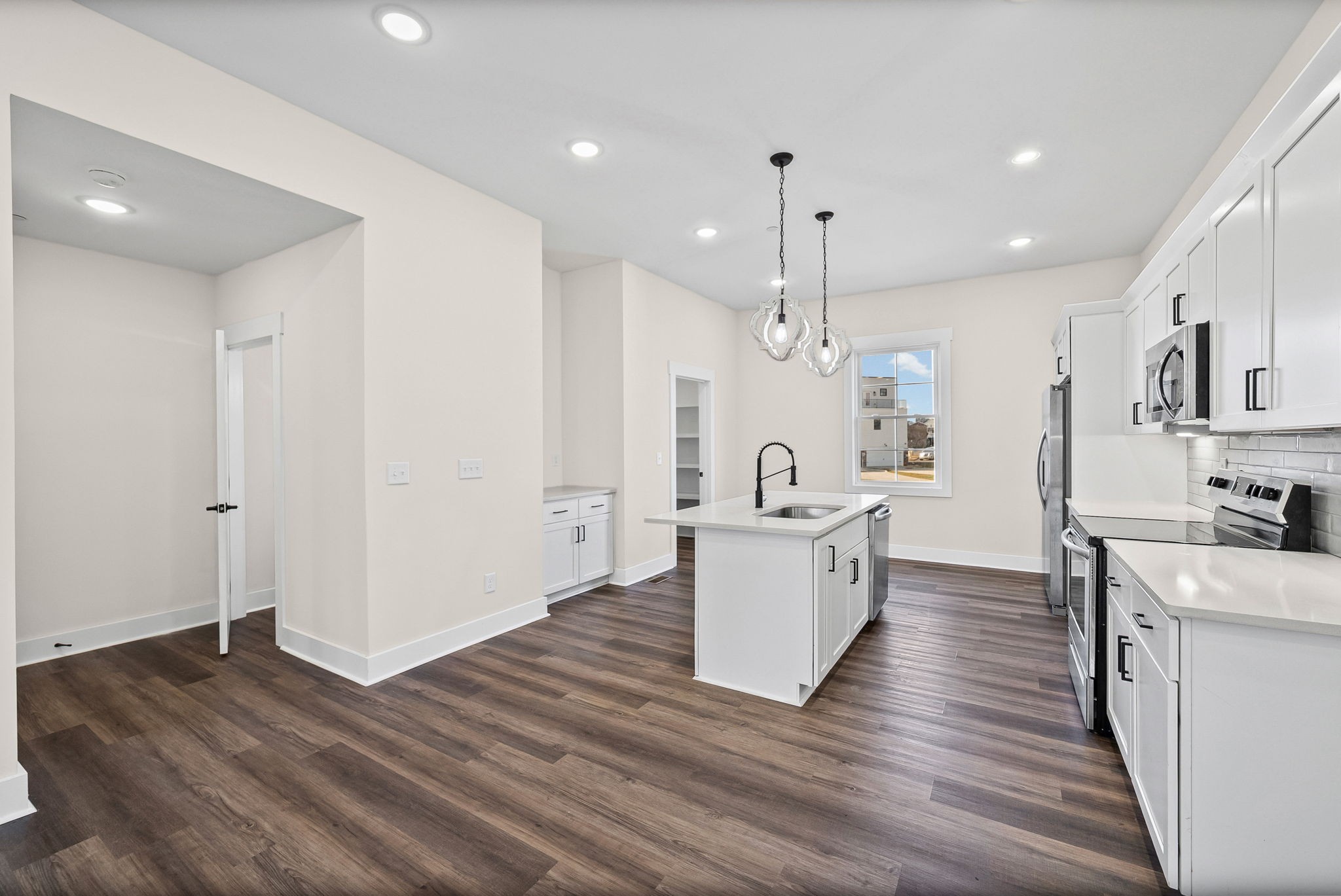 434 Centre Street Pleasant View, TN 37146 - Photo 7 of 44 a large white kitchen with wooden floor