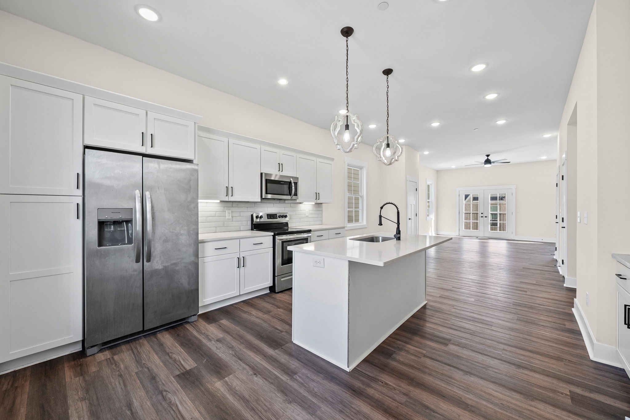434 Centre Street Pleasant View, TN 37146 - Photo 9 of 44 a kitchen with kitchen island white cabinets and stainless steel appliances