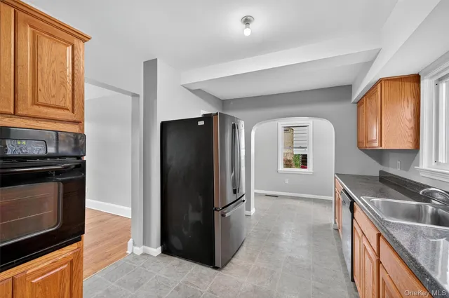 a kitchen with stainless steel appliances granite countertop a refrigerator and a sink