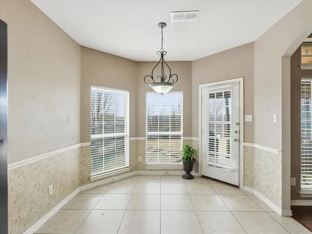 a kitchen with a sink window and cabinets