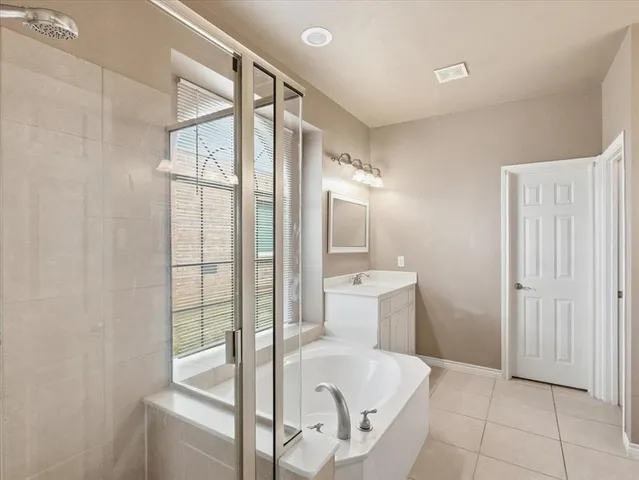 a bedroom with a bed and a ceiling fan