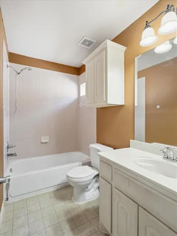 a room with pool table and windows