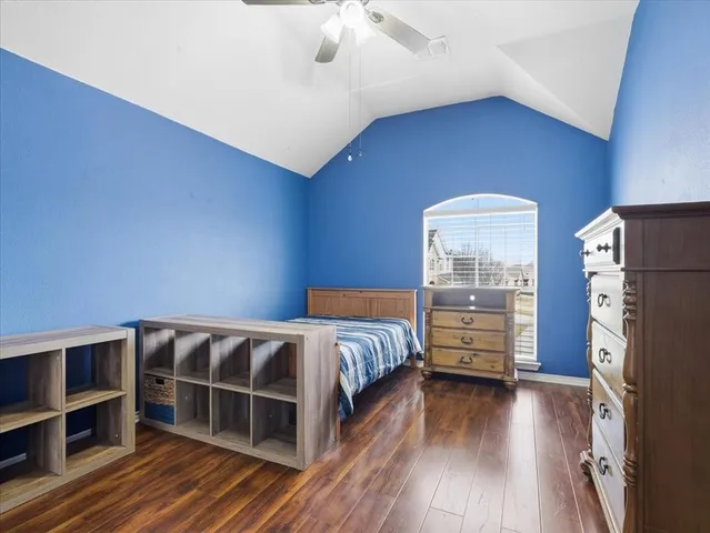 a living room with furniture kitchen view and a large window