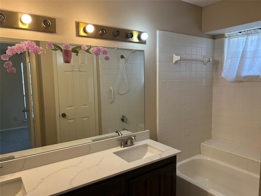 Undisclosed Address Plano, TX 75025 - Photo 11 of 15 a bathroom with a sink vanity tub and shower