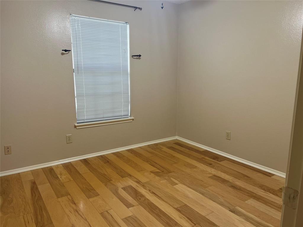Undisclosed Address Plano, TX 75025 - Photo 13 of 15 a view of an empty room with wooden floor and a window