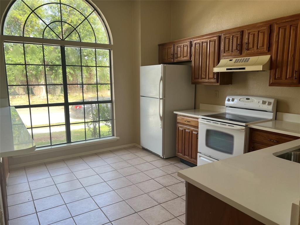 Undisclosed Address Plano, TX 75025 - Photo 4 of 15 a kitchen with a stove top oven and cabinets