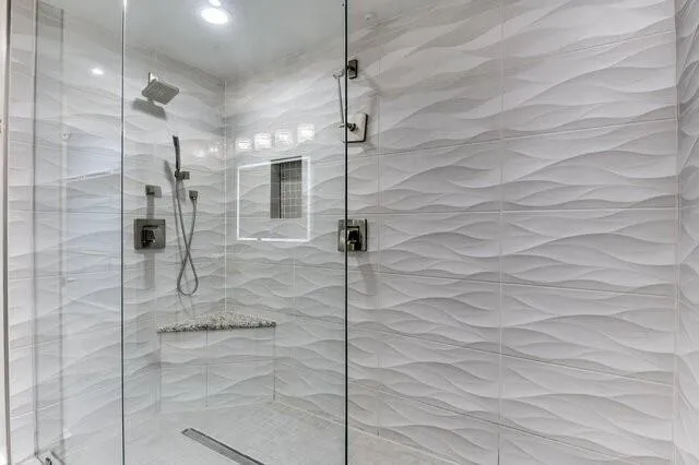 a bathroom with a granite countertop sink a mirror and a shower